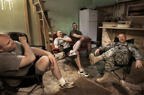 Rick Egan | The Salt Lake Tribune

Michael McLaughlin (second from left), a member of the Utah-based 222nd Field Artillery but a Pennsylvania native, jokes with members of his battalion's command team in the makeshift coffee house at unit headquarters in Ramadi, Iraq on September 12, 2005. McLaughlin later was killed as a result of wounds received from a suicide bomber in Ramadi.
Salt Lake Tribune photo / Rick Egan
