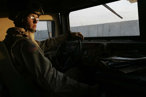Rick Egan | The Salt Lake Tribune

Spc. Justin Tomison checks the traffic at sunrise before pulling his Humvee into the gate at Mosul after an all night convoy October 7, 2005.