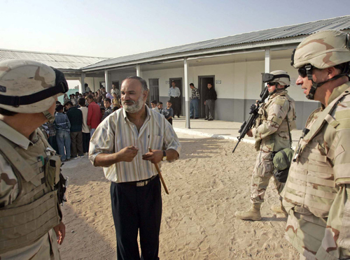 Rick Egan | The Salt Lake Tribune

Soldiers secure the school grounds as Muhammad Jassen (center)  headmaster of the Lights of the Desert Primary School near Najaf, Iraq thanks the soldiers for their help and donations to their school October 16, 2005.