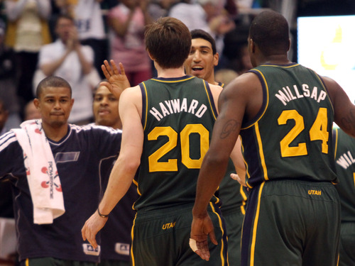 Rick Egan  | The Salt Lake Tribune 

Utah Jazz point guard Earl Watson (11) and Utah Jazz center Enes Kanter (0) greet  Gordon Hayward (20) after he sunks a 3-pointer, giving the Jazz a 6 point lead with 17.3 seconds left in the game,  in NBA action, The Utah Jazz vs. The Memphis Grizzlies at EnergySolutions Arena, Saturday, March 16, 2013.