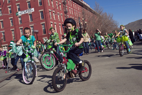 Chris Detrick  |  The Salt Lake Tribune
Students from Saint Andrew Catholic School ride bikes during the Salt Lake City St. Patrick's Day parade Saturday March 16, 2013. The annual parade showcasing Utah's Irish heritage, which celebrates its 35th year today, claims its roots in the first Irish immigrants brought to the state by Park City's mining boom, and even Irish-American soldiers stationed at Fort Douglas as early as 1862.