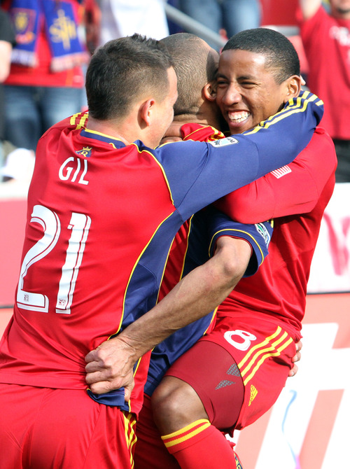 Rick Egan  | The Salt Lake Tribune 

Real Salt Lake forward Jou Plata (8) jumps into the arms of Real Salt Lake forward Alvaro Saboru (15)  and Real Salt Lake midfielder Luis Gil (21) grabs on from behind, after Saboru scored the only goal of the day for Real Salt Lake, as they ended in a 1-1 tie with Colorado, in MLS soccer action, at RIo Tinto Stadium, Saturday, March 16, 2013.
