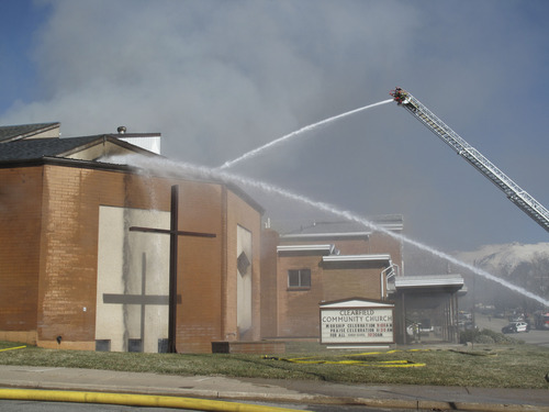 Jessica Miller  |  The Salt Lake Tribune
Fire crews from several Davis County agencies work to fight a blaze sparked Tuesday afternoon in the basement of Clearfield Community Church, 200 S. 500 East, Clearfield.