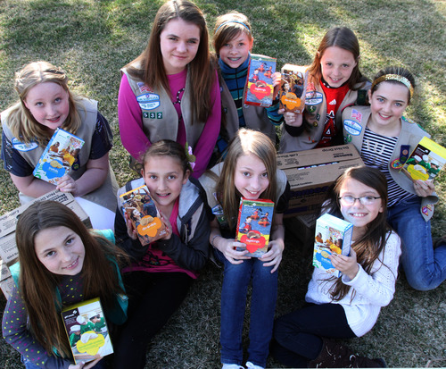 Rick Egan  | The Salt Lake Tribune 

Girl Scouts, Front L-R: Addi Fullerton, Rachel Gallegos, Daisy Fullerton, Kennedi Leon. Back L-R: Natalie Pitts, Rae Steinke, Sarah Kendall, Sid Holtz, and Michaela Boyette, Monday, March 18, 2013.  The girl scouts were robbed Saturday when a man grabbed the cash box off the table where they were selling cookies outside of a Taylorsville Wal-Mart.