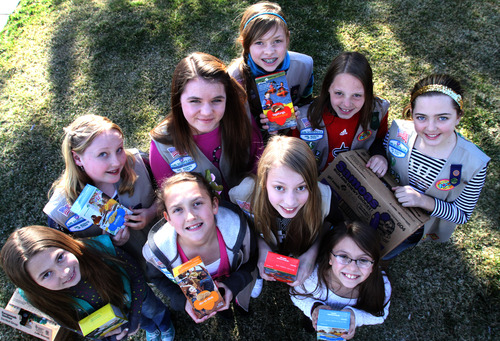 Rick Egan  | The Salt Lake Tribune 

Girl Scouts, Front L-R: Addi Fullerton, Rachel Gallegos, Daisy Fullerton, Kennedi Leon. Back L-R: Natalie Pitts, Rae Steinke, Sarah Kendall, Sid Holtz, and Michaela Boyette, Monday, March 18, 2013.  The girl scouts were robbed Saturday when a man grabbed the cash box off the table where they were selling cookies outside of a Taylorsville Wal-Mart.