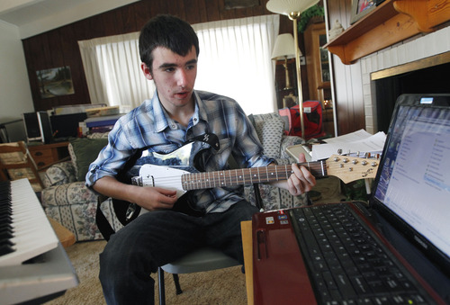 Al Hartmann  |  The Salt Lake Tribune
Chanse Phoenix is one of 600 students across the nation to enroll in the pre-launch online music course called Juilliard eLearning. He works through an online music lesson with guitar, keyboard and laptop from his Murray home. For the first time, K-12 students from rural towns to major cities nationwide can take music courses from their home or local school through new online courses developed by Connections Education.