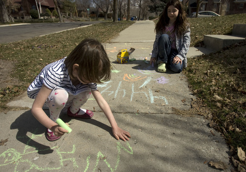 Kim Raff  |  The Salt Lake Tribune
On a warm afternoon, neighbors (left) Clare Scarbrough and Abby Sagron color with chalk on the sidewalk outside of their homes on Emerson Avenue in Salt Lake City on Tuesday March 19, 2013.