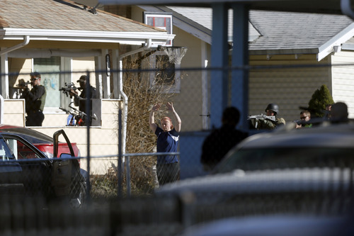 Chris Detrick  |  The Salt Lake Tribune
Law enforcement officers take a suspect into custody near the scene of a shooting at 1159 S. Foulger Street Tuesday March 19, 2013. The shooting occurred as members of the Joint Criminal Apprehension Team surrounded a home in the area of 1100 South between State and Main streets.
