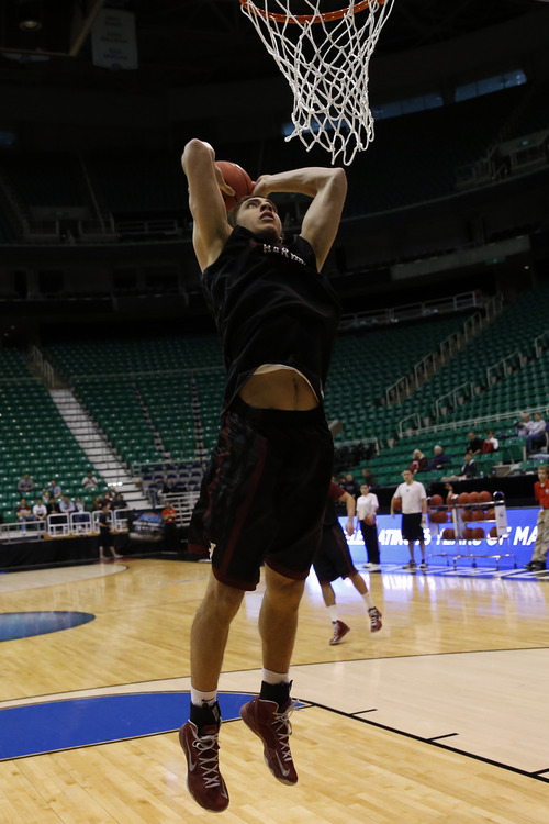 Chris Detrick  |  The Salt Lake Tribune
Harvard Crimson forward Jonah Travis (24) dunks the ball during a practice at EnergySolutions Arena Wednesday March 20, 2013.