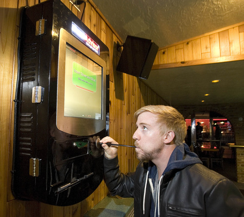 Paul Fraughton  |  The Salt Lake Tribune
Jason Knott demonstrates his BreathAdvisor, a breathalyzer  installed at the Canyon Inn.
 Thursday, March 7, 2013