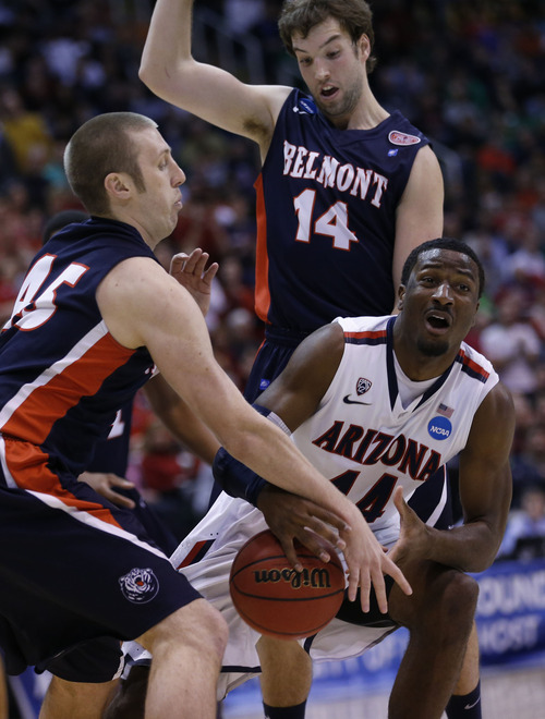 Chris Detrick  |  The Salt Lake Tribune

Belmont Bruins forward Brandon Baker (45) fouls Arizona Wildcats forward Solomon Hill (44) as J.J. Mann (14) also defends as the Wildcats face the Bruins in the NCAA tournament at EnergySolutions Arena on Thursday, March 21, 2013.