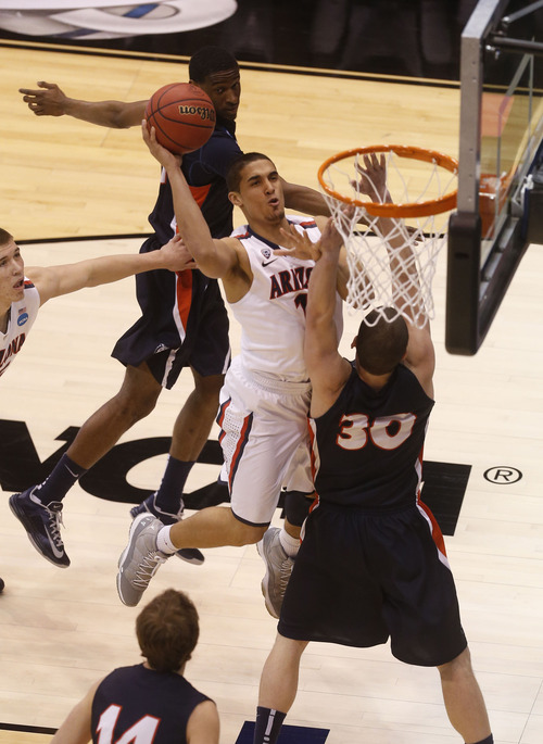 Trent Nelson  |  The Salt Lake Tribune

Arizona Wildcats guard Nick Johnson (13) drives to the hoop over Belmont Bruins forward Trevor Noack (30) as the Wildcats face the Bruins in the NCAA tournament at EnergySolutions Arena on Thursday, March 21, 2013.