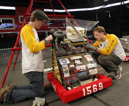 Al Hartmann  |  The Salt Lake Tribune
Daniel Spreier, left, and Tyler Ames from Pocatello Idaho set up their robot on the competition floor at the Maverik Center in West Valley City Thursday March 21.  Forty-four teams from ten states competed in The FIRST Robotics Competition challenges high school Science, Technology, Engineering and Mathematics (STEM).  Students build, design, create and program robots to perform a specific gaming task. The task today was for the robots to throw frisbees through targets across the court.  With the help of professional scientists and engineers, students compete with their own robot, earn a chance to enter the world robotics championship and qualify for over $8 million in college scholarships.