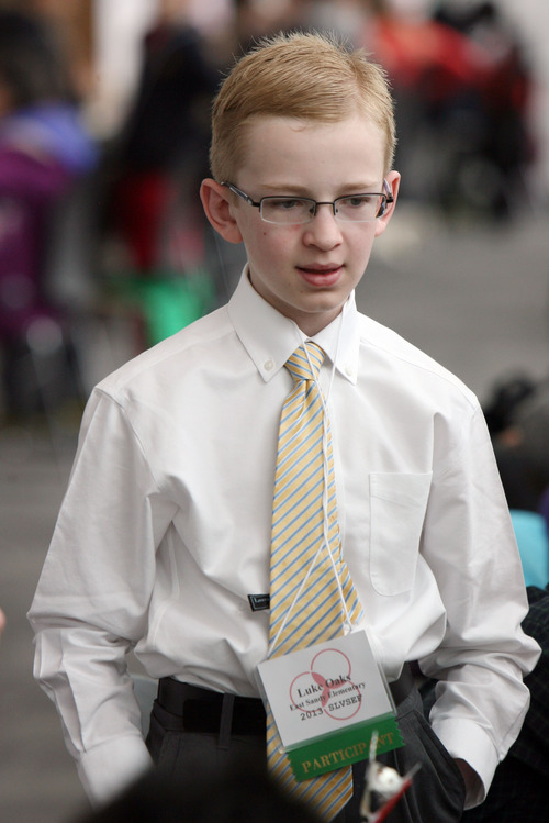 Steve Griffin  |  The Salt Lake Tribune
East Sandy Elementary student Luke Oaks presents his project Thursday at the Salt Lake Valley Science and Engineering Fair, held at the University of Utah's Rice-Eccles Stadium.