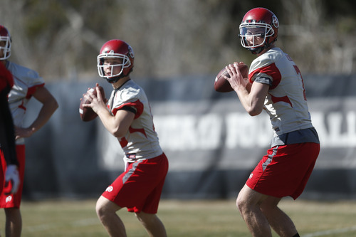 Chris Detrick  |  The Salt Lake Tribune
Utah quarterback Travis Wilson and Adam Schulz throw the ball during spring practice Tuesday March 19, 2013.