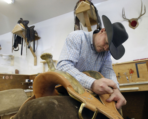 Al Hartmann  |  The Salt Lake Tribune
Zane Osborn, production manager, works on the ground seat of a custom-made saddle at Burns Saddlery shop in Salina.