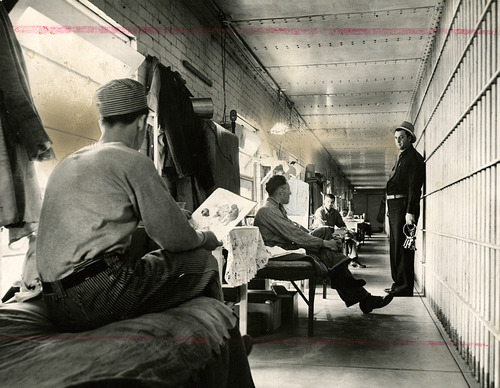 Tribune file photo

Inmates and a guard are seen in a hallway at the old Utah State Prison when it was located at what is now Sugar House Park. This photo is from 1939.