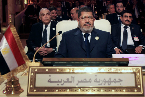 Egyptian President Mohammed Morsi, center, attends the opening session of the Arab League summit in Doha, Qatar, Tuesday, March 26, 2013. Syrian opposition representatives took the country's seat for the first time at an Arab League summit that opened in Qatar on Tuesday, a significant diplomatic boost for the forces fighting President Bashar Assad's regime. (AP Photo/Ghiath Mohamad)