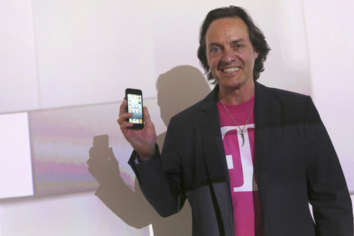 T-Mobile CEO John Legere speaks during a news conference Tuesday, March 26, 2013 in New York. T-Mobile will start offering the iPhone 5 on April 12, filling what Legere said was "a huge void" in its phone lineup. The company is currently the only major U.S. carrier not to offer Apple's popular smartphone. (AP Photo/Mary Altaffer)