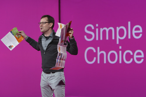 T-Mobile  Chief Marketing Officer Mike Sievert holds brochures if competitors' plans as he speaks during a news conference, Tuesday, March 26, 2013 in New York. T-Mobile will start offering the iPhone 5 on April 12, filling what company CEO John Legere said was "a huge void" in its phone lineup. The company is currently the only major U.S. carrier not to offer Apple's popular smartphone. (AP Photo/Mary Altaffer)