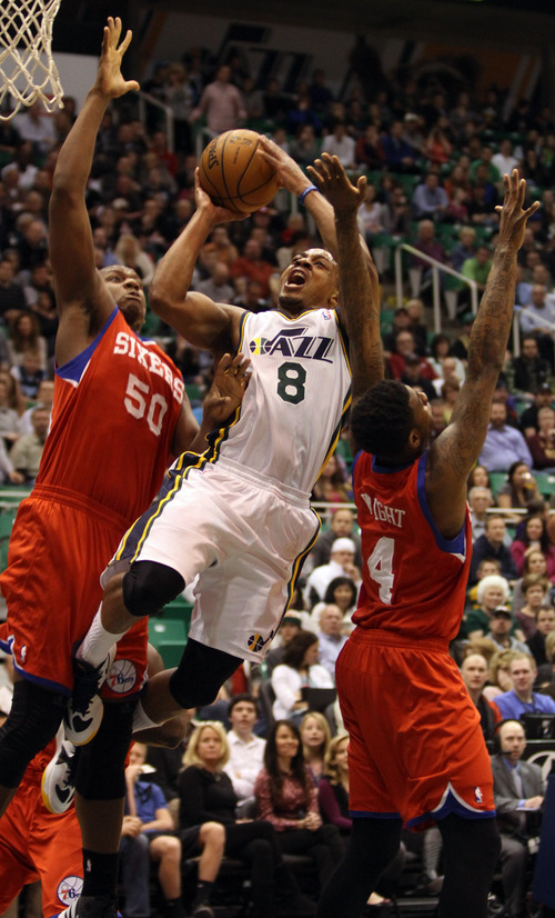 Rick Egan  | The Salt Lake Tribune 

Utah Jazz point guard Randy Foye (8) squeezes between Philadelphia 76ers center Lavoy Allen (50) and Dorell Wright (4) in NBA action, Jazz vs. the Sixers, at EnergySolutions Arena, Monday, March 25, 2013.