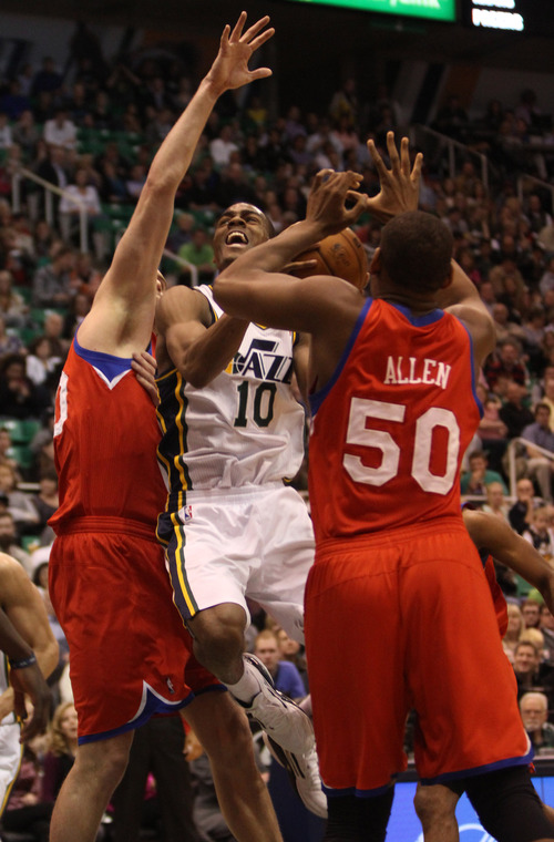 Rick Egan  | The Salt Lake Tribune 

Philadelphia 76ers center Spencer Hawes (00) and Philadelphia 76ers center Lavoy Allen (50) try to stop Utah Jazz point guard Alec Burks (10) as he goes in for a shot,  in NBA action, Jazz vs. the Sixers, at EnergySolutions Arena, Monday, March 25, 2013.