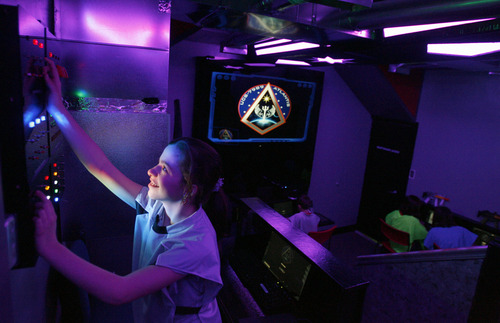 Rick Egan  | The Salt Lake Tribune 

Claire Johnson, 13, works the controls in the Atlantis spaceship at the Discovery Space Center in Pleasant Grove, Tuesday, March 26, 2013.