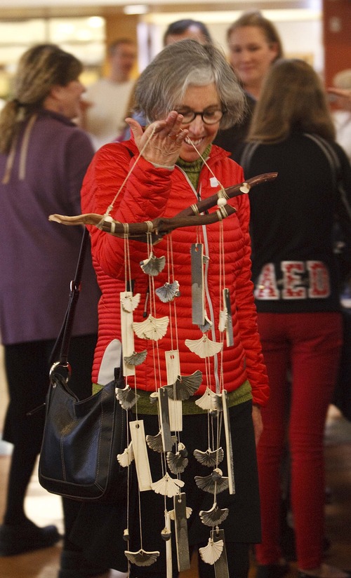Leah Hogsten  |  The Salt Lake Tribune
Carolyn Hoffman, who studied with Kay Kuzminski, proudly walks off with her gingko pottery wind chime at the sale. In under two hours, the majority of wheel-thrown cups, bowls, plates, ceramic jewelry and other items created by Westminster ceramics students and ceramics professor, Kay Kuzminski were sold Wednesday, March 27, 2013 for charity in the Shaw Student Center. Kay Kuzminski, professor of art at Westminster College is retiring after 38 years of inspiring thousands of students to think creatively, both in and out of the art studio.