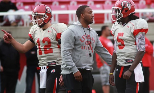 Leah Hogsten  |  The Salt Lake Tribune
University of Utah football team's Brian Johnson runs through plays with  quarterback Brandon Cox (right) and Adam Schulz (left) during the Utes practice, Tuesday, March 26, 2013. Johnson has been demoted from offensive coordinator, but still coaches the quarterbacks as the "co-coordinator" with the newly hired Dennis Erickson.