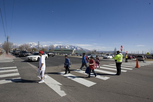 Paul Fraughton  |   Salt Lake Tribune
Crossing guards help children across 6200 South  at an intersection near Westbrook Elementary School. Funding was made available for a pedestrian bridge near the school as well as  a new signalized  intersection.
 Tuesday, March 19, 2013
