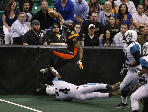 Scott Sommerdorf   |  The Salt Lake Tribune
Blaze WR Mario Urrutia gives Blaze fans something to get excited about as he runs after a catch while jumping over Rattlers DB Virgil Gray during first half play. The Blaze were down 33-28 at the half in their Arena League home opener against the Arizona Rattlers, Friday, March 29, 2013.