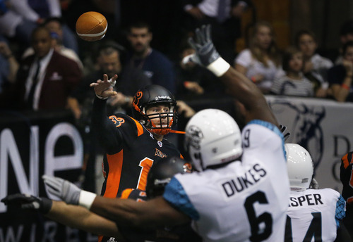 Scott Sommerdorf   |  The Salt Lake Tribune
Blaze QB Tommy Grady gets off a pass under pressure during first half play. The Blaze were down 33-28 at the half in their Arena League home opener against the Arizona Rattlers, Friday, March 29, 2013.