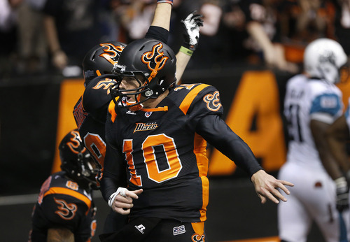 Scott Sommerdorf   |  The Salt Lake Tribune
Blaze QB Tommy Grady and WR Chase Deader celebrate a TD hookup during first half play. The Blaze were down 33-28 at the half in their Arena League home opener against the Arizona Rattlers, Friday, March 29, 2013.