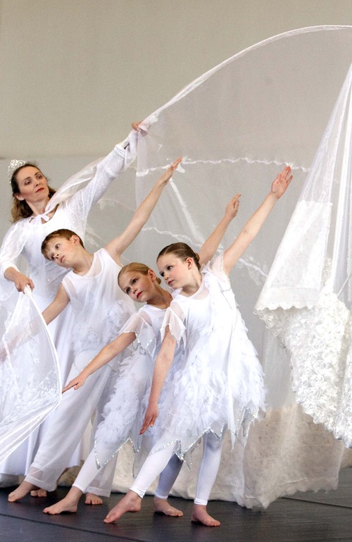 Leah Hogsten  |  The Salt Lake Tribune
Chara Huckins-Malaret plays the snow queen with Elijah Cook, 9, Abbigal Wright, 10 and Emelia Nelson, 9, of the Children's Dance Theatre rehearses for the upcoming production of The Snow Queen at the George Thomas Building on the University of Utah campus,Thursday, March 22, 2013.