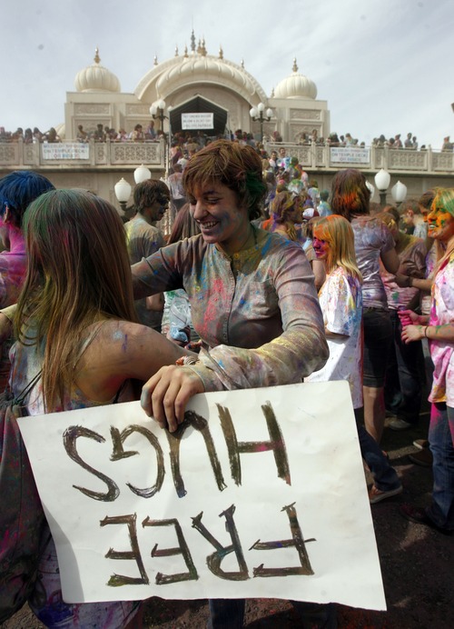 Francisco Kjolseth  |  The Salt Lake Tribune
Laura Crenshaw, of Tucson, Ariz., givesfree hugs as revelers dance to the music and throw bright colorful chalk made of edible maize during Holi, the Festival of Colors at Sri Radha Krishna Temple in Spanish Fork, Utah, March 24, 2012. The 2013 version happens Saturday, March 30.