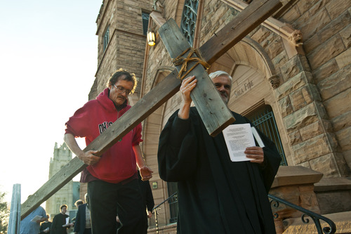 Chris Detrick  |  The Salt Lake Tribune
Alex Bury, of Sunset, and the Rev. Michael J. Imperiale, pastor of First Presbyterian Church, carry a wooden cross from First Presbyterian Church during the Good Friday Procession of the Cross Friday March 29, 2013. Since 1983, the Salt Lake Council of Churches has sponsored this annual procession, which is similar to the tradition of the "Via Dolorosa" (Way of Suffering), where pilgrims to Jerusalem follow the path Jesus took to the cross.
