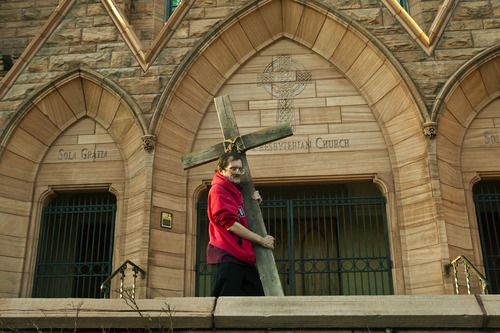 Chris Detrick  |  The Salt Lake Tribune
Alex Bury, of Sunset, carries a wooden cross from the Cathedral of the Madeleine to First Presbyterian Church during the Good Friday Procession of the Cross Friday March 29, 2013. Since 1983, the Salt Lake Council of Churches has sponsored this annual procession, which is similar to the tradition of the "Via Dolorosa" (Way of Suffering), where pilgrims to Jerusalem follow the path Jesus took to the cross.