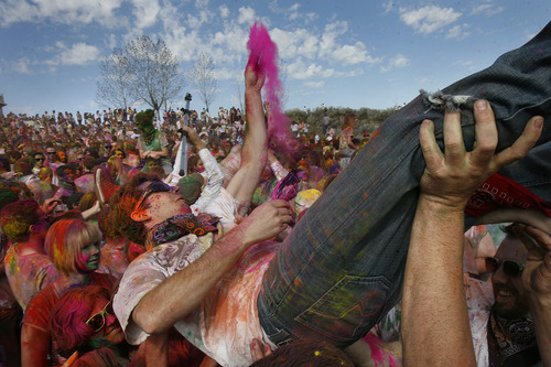 Scott Sommerdorf   |  The Salt Lake Tribune
"Crowd surfing" at the 2013 Festival of Colors - Holi Celebration - at the Krishna Temple in Spanish Fork, Saturday, March 30, 2013. The festival celebrates Holi, the announcement of the arrival of spring.