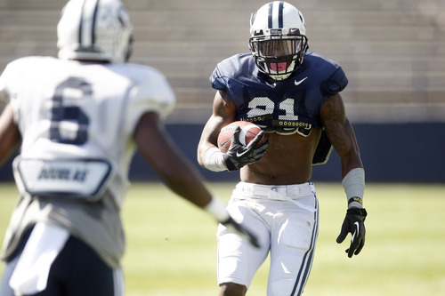 Chris Detrick  |  The Salt Lake Tribune
Brigham Young Cougars running back Jamaal Williams (21) runs past Brigham Young Cougars defensive back Jordan Johnson (6) during the spring scrimmage at LaVell Edwards Stadium Saturday March 30, 2013.