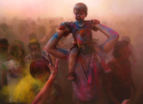 Scott Sommerdorf   |  The Salt Lake Tribune
Michael Elliott of Layton, holds his son Camden on his shoulders as the third "throw" of the day takes place at the 2013 Festival of Colors - Holi Celebration - at the Krishna Temple in Spanish Fork, Saturday, March 30, 2013. The festival celebrates Holi, the announcement of the arrival of spring.