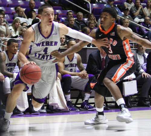 Rick Egan  | The Salt Lake Tribune 

Weber State Wildcats guard Scott Bamforth (4) takes the ball inside, as Idaho State Bengals guard Melvin Morgan (3) defends,  in basketball action at the Dee Event Center in Ogden, Monday, February 11, 2013.