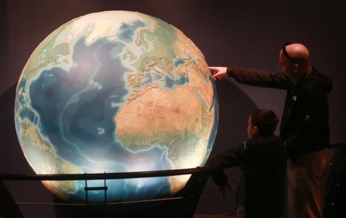 Kim Raff  |  The Salt Lake Tribune
(left) Mason Frasure and his father, Lance Frasure, look at the Earth Globe exhibit during their visit to the Clark Planetarium in Salt Lake City on March 25, 2013. The planetarium is celebrating its 10th anniversary.
