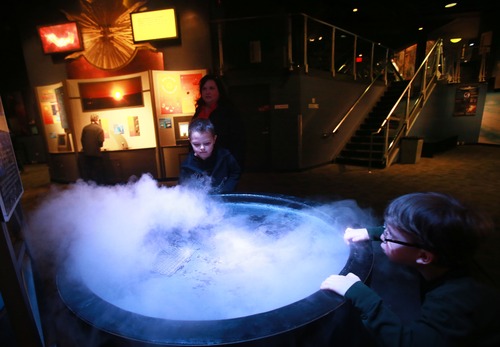 Kim Raff  |  The Salt Lake Tribune
(left) Ryan Bradshaw and Brody Wheeldon play in an exhibit about clouds at the Clark Planetarium in Salt Lake City on March 25, 2013. The planetarium is celebrating its 10th anniversary.