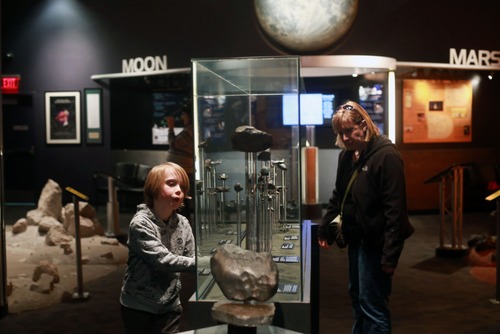 Kim Raff  |  The Salt Lake Tribune
(left) Dyson Echols and his mother, Charity Echols, look at the collection of meteorites at the Clark Planetarium in Salt Lake City on March 25, 2013. The planetarium is celebrating its 10th anniversary.