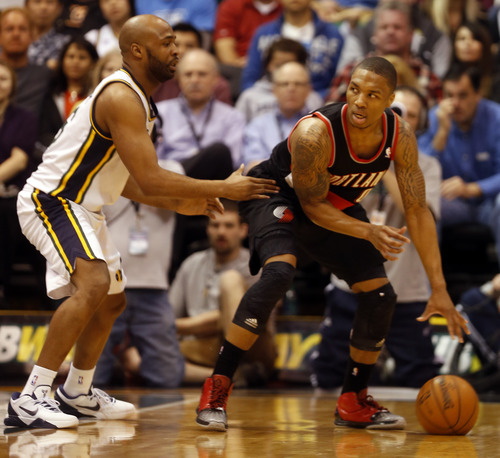 Rick Egan  | The Salt Lake Tribune 

Portland Trail Blazers point guard Damian Lillard (0) dribbles the ball, as Utah Jazz point guard Jamaal Tinsley (6) defends, in NBA action, as the Jazz faced the Portland Trailblazers, at EnergySolutions Arena, Monday, April 1, 2013.