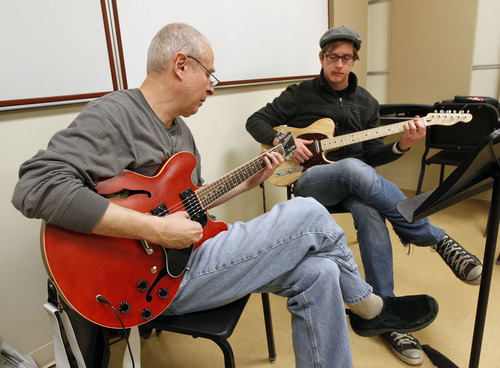 Al Hartmann  |  The Salt Lake Tribune
Music teacher and performer Rich Dixon, left,  teaches a private guitar lesson to John Carter, a music major at Snow College in Ephraim.   The predominantly Mormon school will be particularly hard-hit by the lowered missionary age which will affect enrollment.