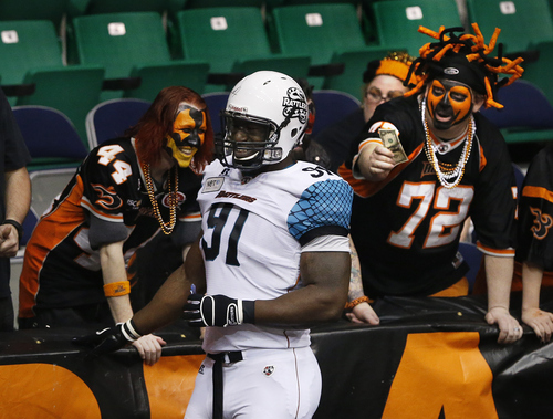 Scott Sommerdorf   |  The Salt Lake Tribune
Blaze fans in "The Fire Pit" tease Arizona Rattlers DL Antron Dillon by jokingly offering him a bribe before a kickoff in the first half on Friday, March 29, 2013.