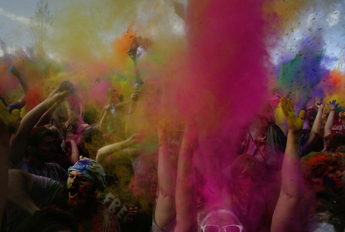 Scott Sommerdorf   |  The Salt Lake Tribune
People dance inside a cloud of colors as the first "throw" of the 2013 Festival of Colors - Holi Celebration - takes place at the Krishna Temple in Spanish Fork, Saturday, March 30, 2013. The festival celebrates Holi, the announcement of the arrival of spring.