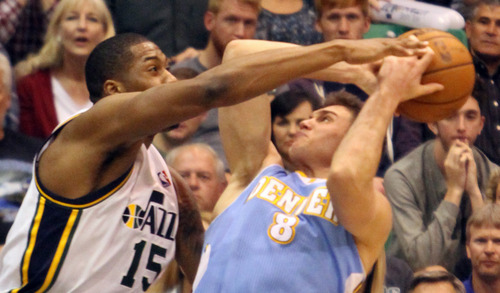 Rick Egan  | The Salt Lake Tribune 

Utah Jazz power forward Derrick Favors (15) defends, as Denver Nuggets small forward Danilo Gallinari (8) gets off a shot for 2 points, in NBA action at the EnergySolutions Arena, Wednesday, April 3, 2013.