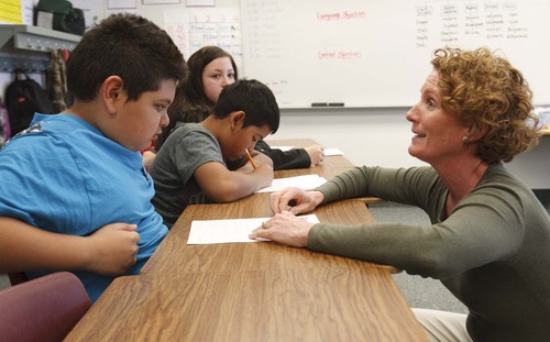 Leah Hogsten  |  The Salt Lake Tribune
Teacher Margot Bishop, right, assists Edgar Edson with his handwriting. In Bishop's fifth-grade classroom at Copperview Elementary students practice their cursive handwriting on Wednesday, April 3, 2013. The Utah school board will take a preliminary vote Friday on whether to keep cursive instruction in Utah schools.